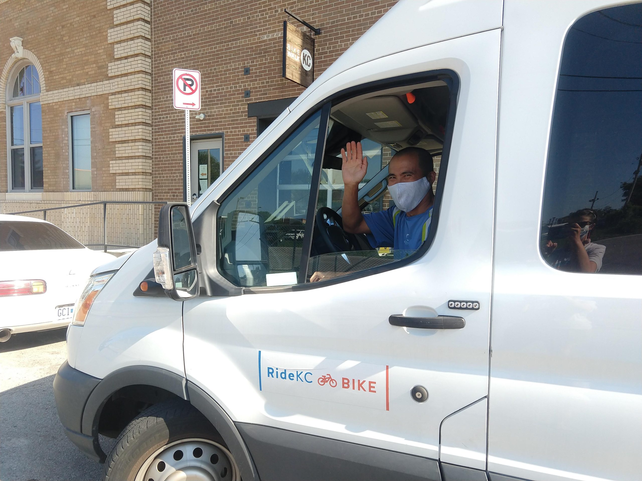 Bike Share KC staff member Chuong waves from the driver's seat of our white operations van.