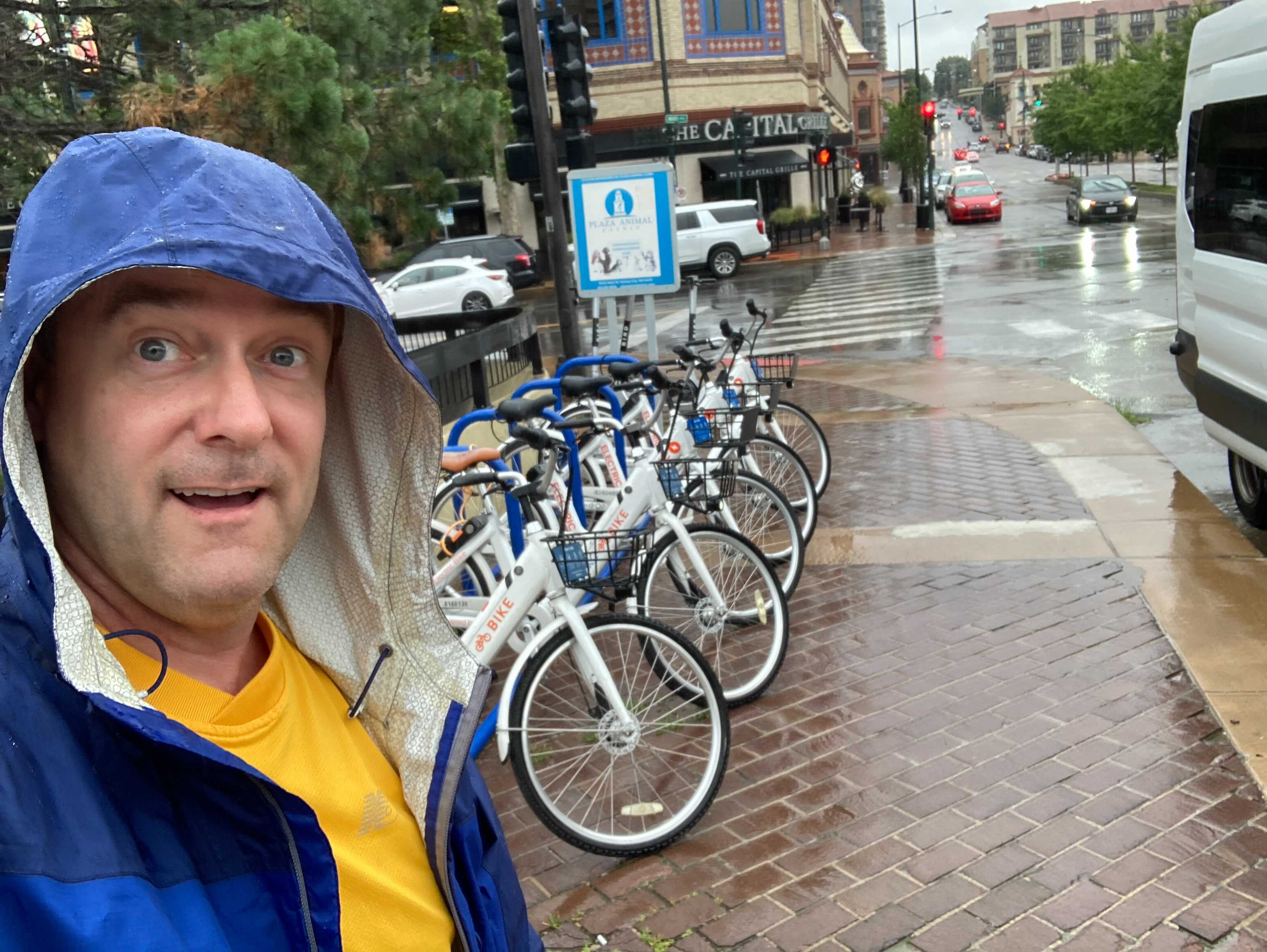 A Bike Share KC team member shuffles bikes on a rainy day