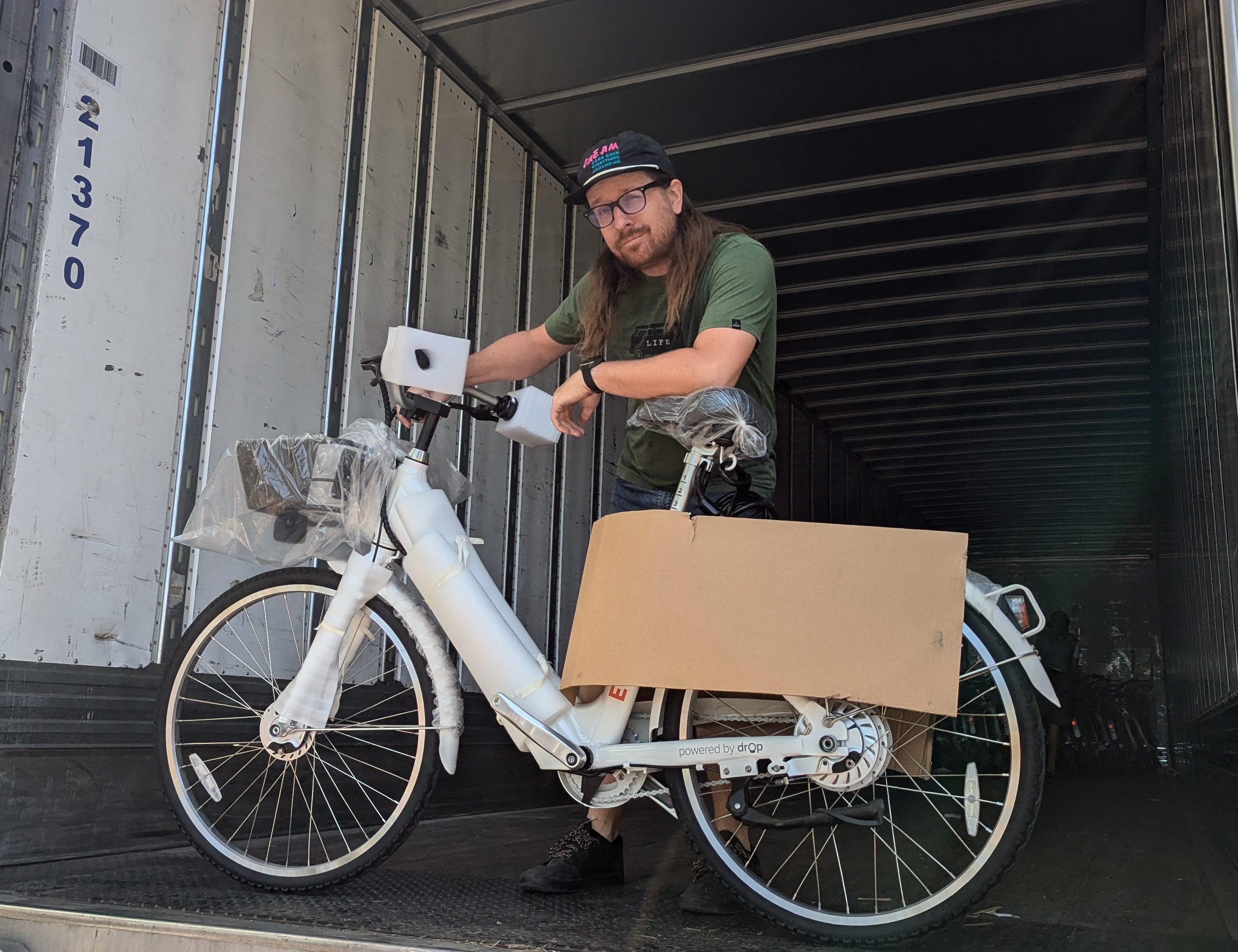 A BikeWalkKC team member unloads a shipment of bikes