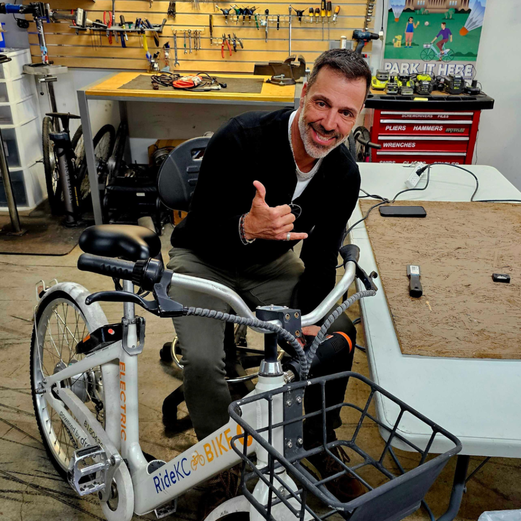 Volunteer from Velo Garage works on a bike