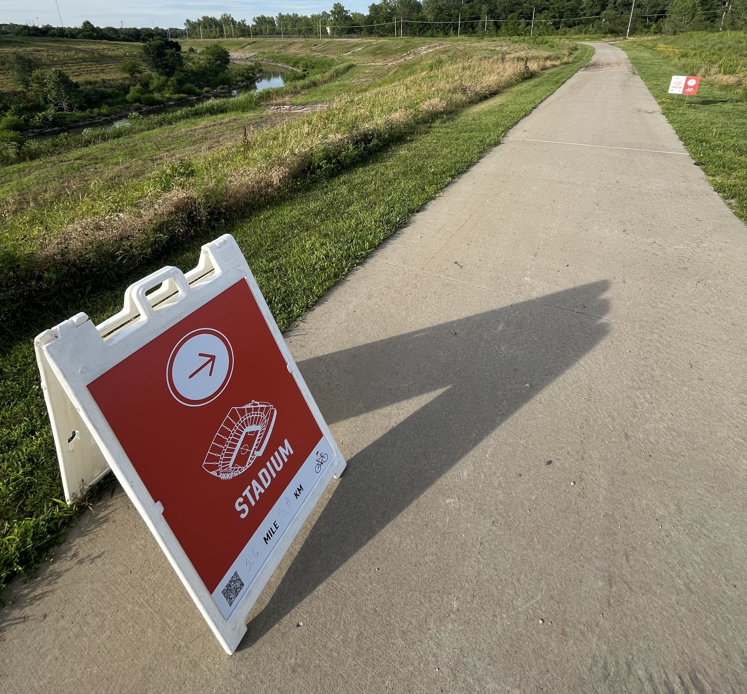 Signs on the Blue River Trail point riders toward KC Stadium